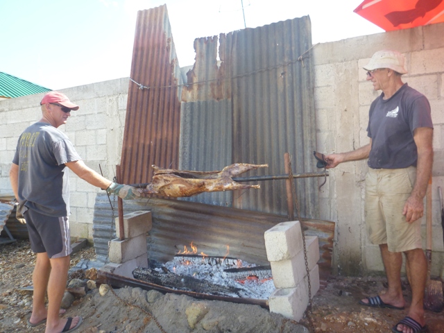 Brett & Brian setting up a system to rotate the lamb on the spit