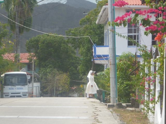 Nun walking along the main road to church